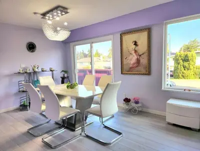 a dining room with a table and white chairs at private single room in a house in Richmond