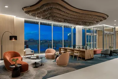 a lobby with a table and chairs and windows at Delta Hotels by Marriott Vancouver Delta in Delta