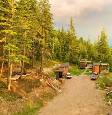 a group of camping sites in the woods at Golden Tiny Homes in Golden
