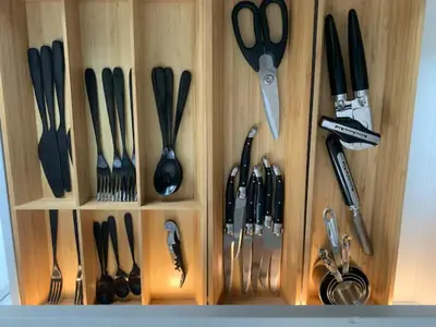 a wooden drawer filled with utensils at Golden Tiny Homes in Golden