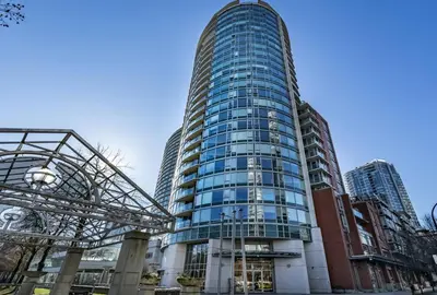 a tall glass building in front of some buildings at Downtown King Suite-Surround Views-Pool/Gym/Parkng in Vancouver