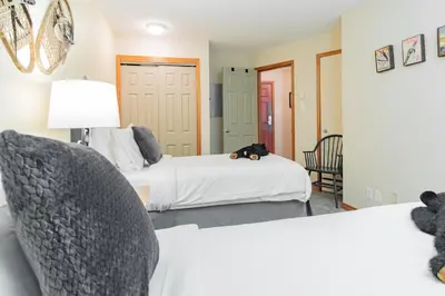a room with two beds and a chair in it at The best ski in ski out two bedroom condo at Aspens in Whistler