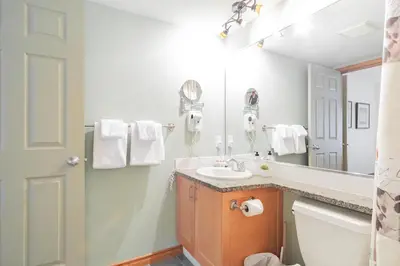 a bathroom with a sink and a mirror at The best ski in ski out two bedroom condo at Aspens in Whistler