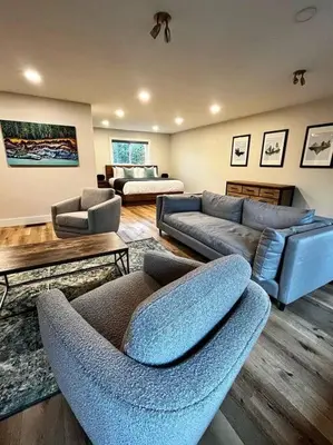 a living room with a couch and chairs and a living room at Two Bedroom House by Snow Valley Lodging in Fernie