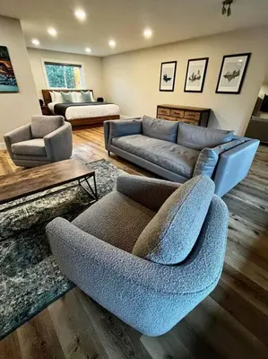 a living room with a couch and a couch and chairs at Two Bedroom House by Snow Valley Lodging in Fernie