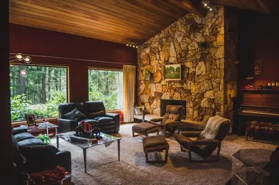 a living room filled with furniture and a stone wall at Misty Meadows B and B in Langford