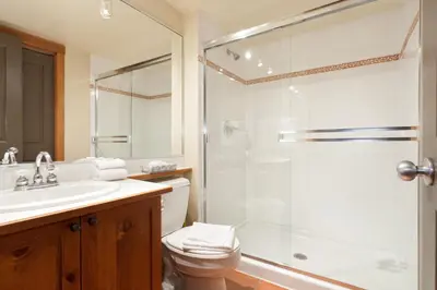 a bathroom with a shower and a toilet and a sink at Lost Lake Lodge by Whistler Premier in Whistler