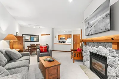 a living room with a couch and a fireplace at Lost Lake Lodge by Whistler Premier in Whistler