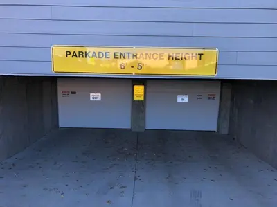 a sign in a parking garage entrance hatch at Royal Blue Wild Oasis Corner PNHSE KingBed U/G Wi-fi in Edmonton