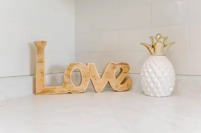 a wooden sign that says wow next to a white vase at Royal Blue Wild Oasis Corner PNHSE KingBed U/G Wi-fi in Edmonton
