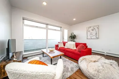 a living room with a red couch and two chairs at Hot Arabaian NightsCornerPNHSEkingWifiU/G in Edmonton