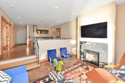 a living room with blue chairs and a fireplace at Salishan Chief Suite by EMR Vacation Rentals in Cowichan Bay