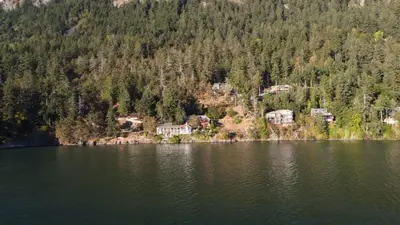 an aerial view of a lake with houses and trees at Salishan Chief Suite by EMR Vacation Rentals in Cowichan Bay