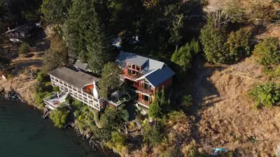 an aerial view of a house on the water at Salishan Chief Suite by EMR Vacation Rentals in Cowichan Bay