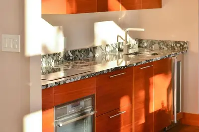 a kitchen with a sink and a stove top oven at Salishan Tree House Suite by EMR Vacation Rentals in Cowichan Bay