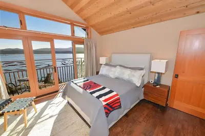 a bedroom with a bed with a view of the ocean at Salishan Tree House Suite by EMR Vacation Rentals in Cowichan Bay