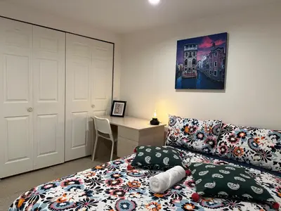 a bedroom with a bed and a desk at Private room in a Shared house in Vancouver
