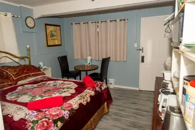a bedroom with a bed and a table with chairs at Guest Suite - Private Retreat - J-1 in Abbotsford