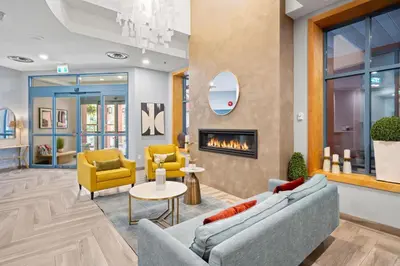 a lobby with two couches and a fireplace at Alpenglow Lodge Cozy Studio with Den by MVA in Whistler