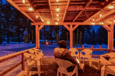 a person sitting on a chair under a pergola at RidgeView Resort in Radium Hot Springs