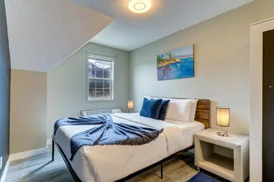 a bedroom with a bed and a window at Amazing mountain views 1bd Apartment Canmore Banff in Canmore