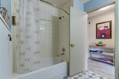 a bathroom with a tub and a shower stall at Amazing mountain views 1bd Apartment Canmore Banff in Canmore