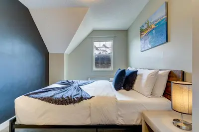 a bedroom with a bed and a window at Amazing mountain views 1bd Apartment Canmore Banff in Canmore