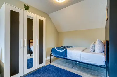 a bedroom with a bed and a blue rug at Amazing mountain views 1bd Apartment Canmore Banff in Canmore