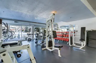 a gym with treadmills and machines in a room at Chateau Canmore in Canmore