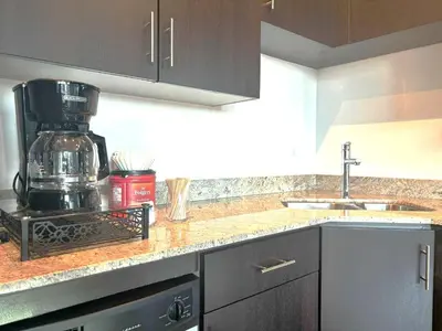 a kitchen with a coffee maker on a counter at Stylish 1BR, Stampede & Free Parking by Doorbed in Calgary