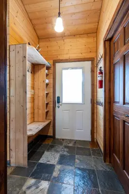 a room with a white door and a window at The Qu INN - Cozy Cabin in Parson