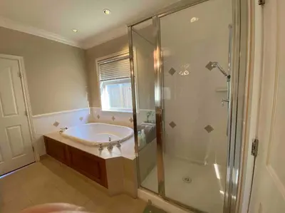 a bathroom with a shower and a sink and a tub at Lucky suite, two-bedroom suite with independent entrance in Richmond close to YVR in Richmond