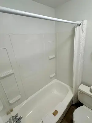 a bathroom with a white tub and a toilet at Anavada Inn & Suites - Grande Prairie in Grande Prairie