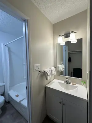 a bathroom with a sink and a shower at Anavada Inn & Suites - Grande Prairie in Grande Prairie