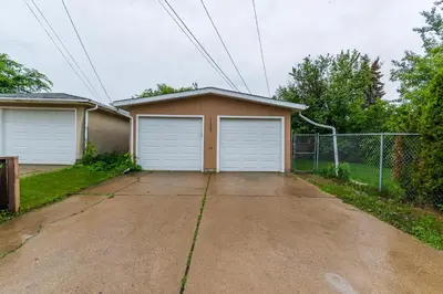 a house with two garage doors in a driveway at Southgate 5 Bedroom Vacation Home with Double Garage in Edmonton