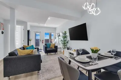 a living room and dining room with a table and chairs at You will love this 2BR Guest Suite in SE Calgary in Calgary