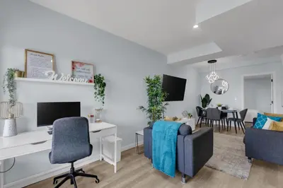 an open living room with a desk and chairs at You will love this 2BR Guest Suite in SE Calgary in Calgary