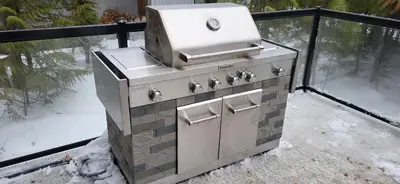 an outdoor stove with a grill on top of it at Fernie Escape - Mountain Home on the Ski Hill in Fernie