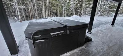 a trash can sitting in the snow with trees in the background at Fernie Escape - Mountain Home on the Ski Hill in Fernie