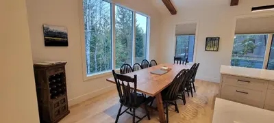 a dining room with a wooden table and chairs at Fernie Escape - Mountain Home on the Ski Hill in Fernie