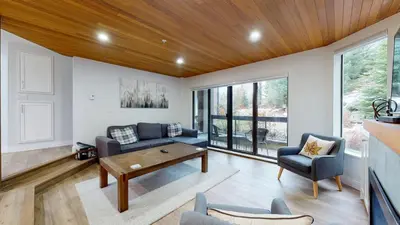 a living room with a couch and a table at Ironwoods on Blueberry Hill by Whistler Blackcomb Vacation Rentals in Whistler
