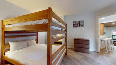 a bedroom with two bunk beds and a desk at Ironwoods on Blueberry Hill by Whistler Blackcomb Vacation Rentals in Whistler