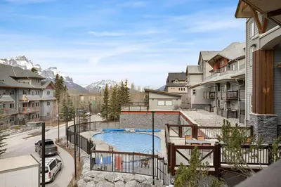 a balcony with a swimming pool and some buildings at Beautiful Renovated Wolf 2Bed 2Bath in Canmore