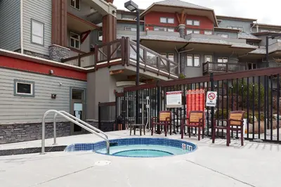 a small swimming pool in front of a building at Beautiful Renovated Wolf 2Bed 2Bath in Canmore