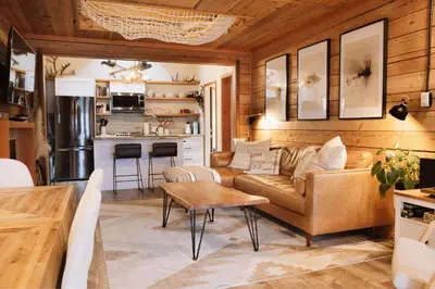 a living room with a couch and a table at The Kootenay Lake House - A Private Luxury Retreat in Nakusp
