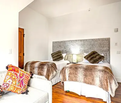 a bedroom with two beds and a couch at Luxury Penthouse At Solar A Resort And Spa in Canmore
