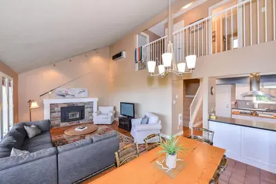 a living room with a couch and a fireplace at Kye Bay Winter Beach House by EMR Vacation Rentals in Comox