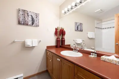 a bathroom with a sink and a mirror at Deer Run by Whistler Premier in Whistler