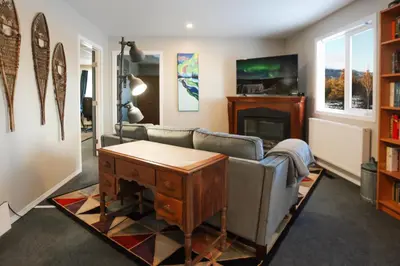 a living room with a couch and a fireplace at The Big Red Barn in Whitehorse