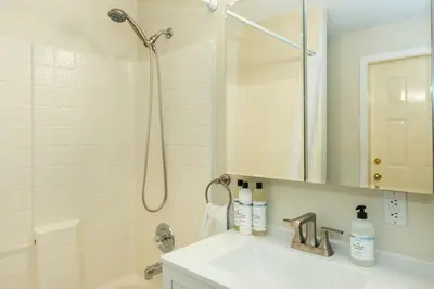 a white bathroom with a shower and a sink at NN - The Summit - Copper Ridge 1-bed 1-bath in Whitehorse